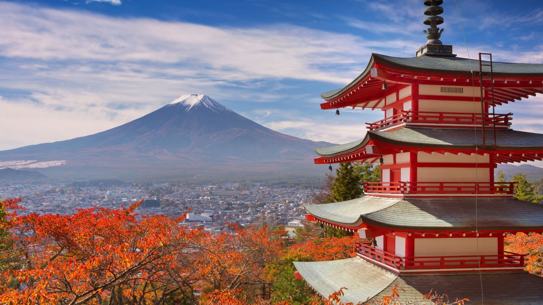 The red Chureito Pagoda with snow-capped Mount Fuji behind it