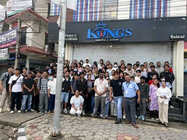 A large group of students and staff standing together on a street in Butwal