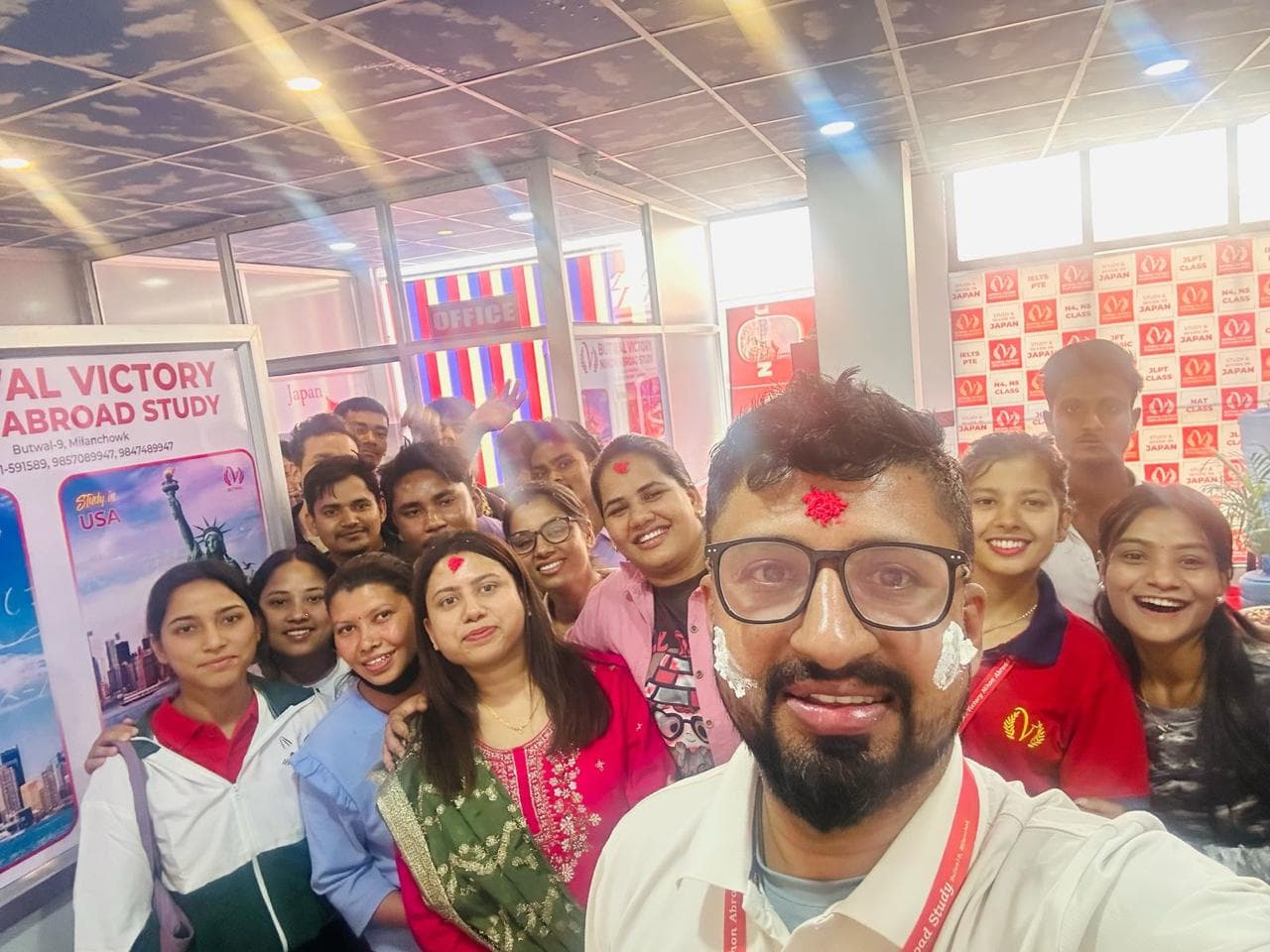 Smiling team members and students gathered together inside the BSB Global office